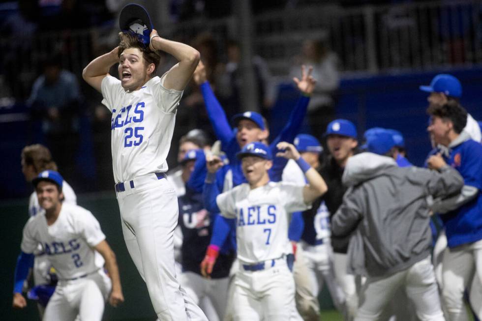 Bishop Gorman players including pitcher Kamdyn Perry (25) celebrate as their first baseman East ...