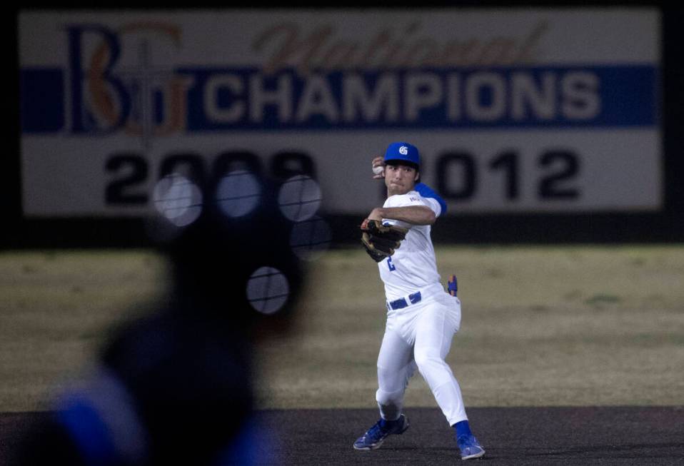 Bishop Gorman second baseman Maddox Riske throws to first for an out as Basic attempts to make ...