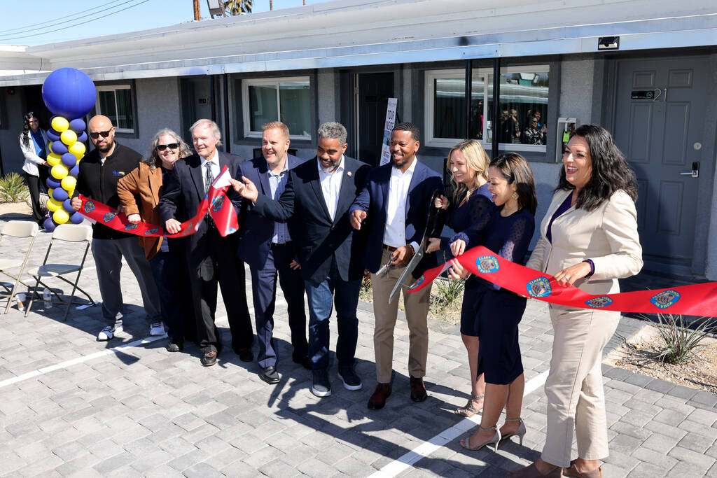 Dignitaries cut the ribbon to open the BETterment Community at the former Safari Motel in downt ...