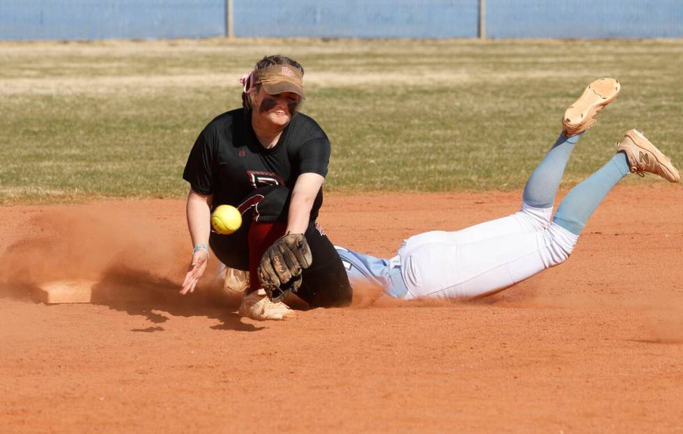 Desert Oasis' Veyda Simon (12) struggles to grab the ball as Centennial's Jill Halas (11) safel ...