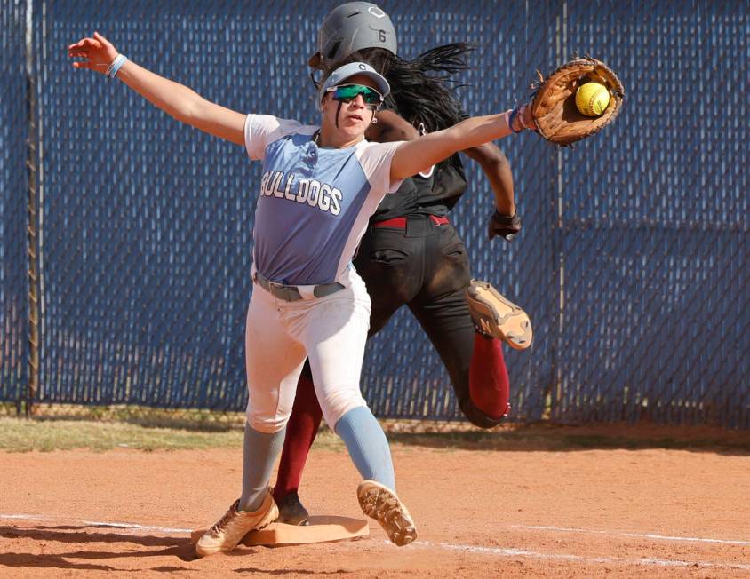 Desert Oasis' Taylor Adams (6) safely runs into the first as Centennial's Carmella Korte (5) re ...