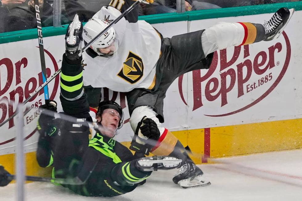 Dallas Stars defenseman Esa Lindell (23) is knocked down by Vegas Golden Knights center Nicolas ...