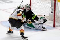 Dallas Stars goaltender Jake Oettinger (29) blocks a shot on goal by Vegas Golden Knights left ...