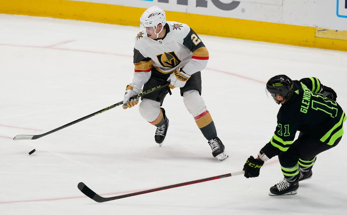 Vegas Golden Knights defenseman Zach Whitecloud (2) skates with the puck as Dallas Stars center ...