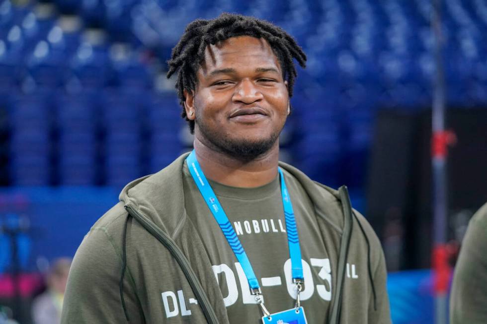 Georgia defensive lineman Jalen Carter watches as players warm up on the field before the NFL f ...