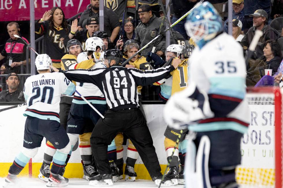 Golden Knights players fight with the Seattle Kraken during the first period of an NHL hockey g ...