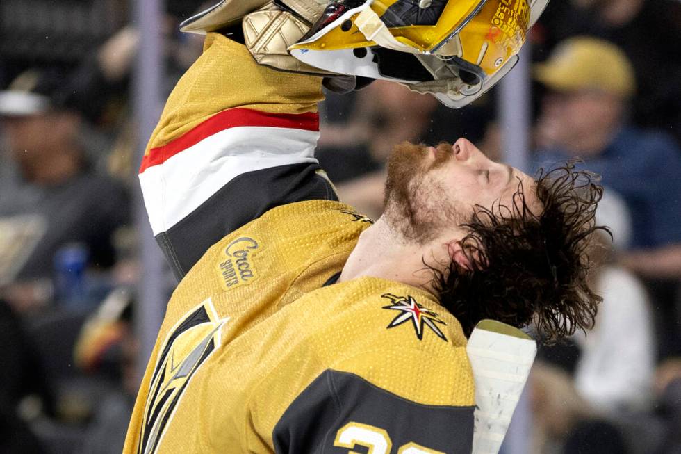 Golden Knights goaltender Laurent Brossoit (39) shakes his hair out during the second period of ...