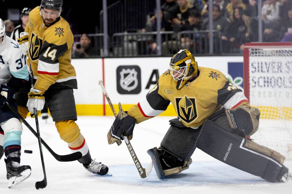 Golden Knights goaltender Laurent Brossoit (39) prepares to save while defenseman Nicolas Hague ...