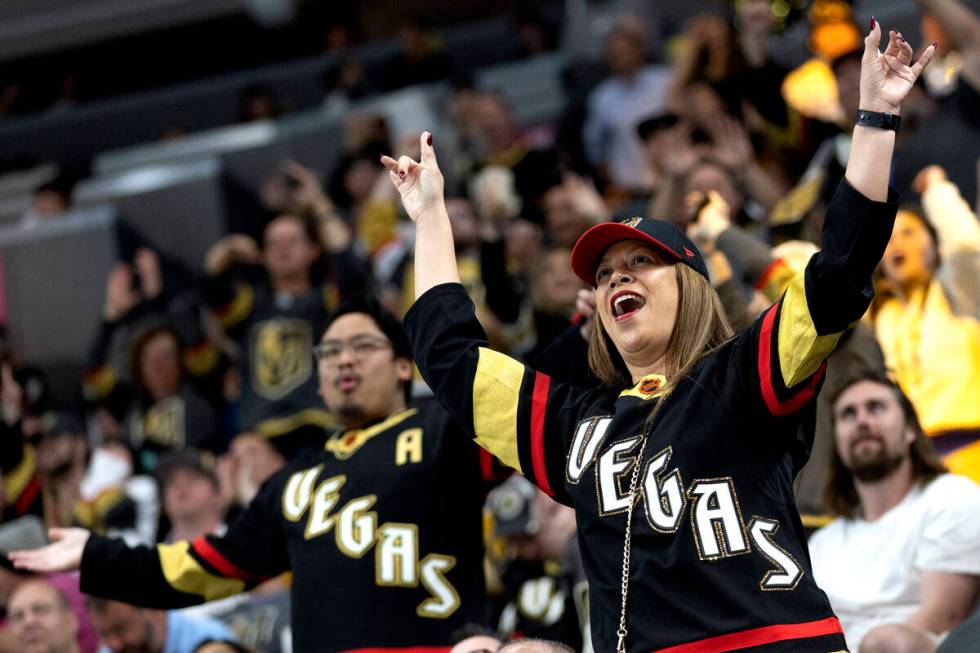 Golden Knights fans cheer during the third period of an NHL hockey game against the Seattle Kra ...