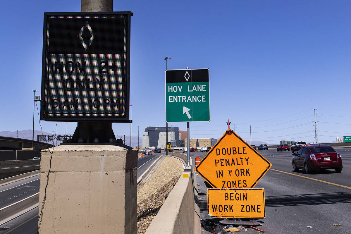 HOV lane signs are posted on northbound Interstate 15, near Spaghetti Bowl, on Monday, April 10 ...