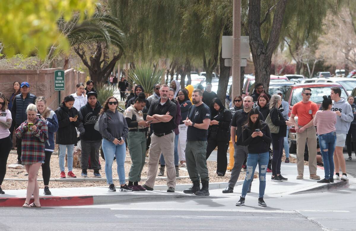 Parents wait outside of Shadow Ridge High School on Wednesday, March 29, 2023, in Las Vegas. (C ...