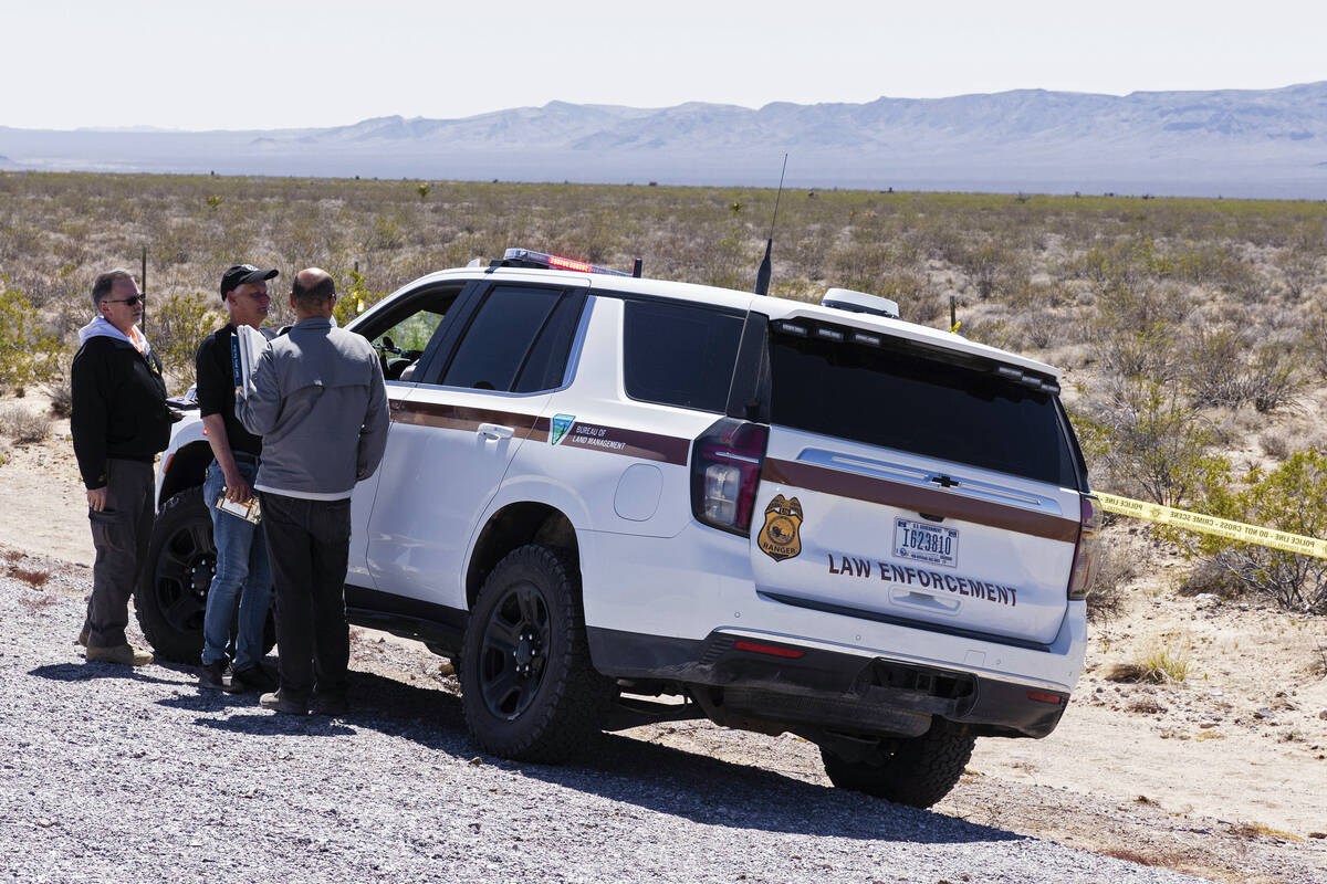 Officials from the FAA gathered near the scene of a plane crash where two people died, on Tuesd ...