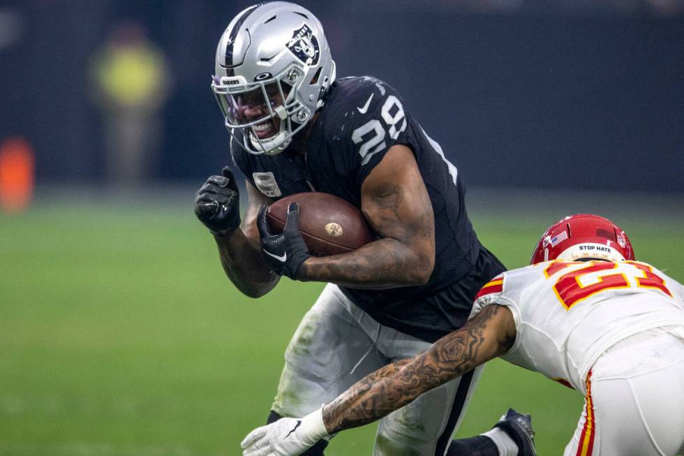 Raiders running back Josh Jacobs (28) rushes against Kansas City Chiefs cornerback Trent McDuff ...