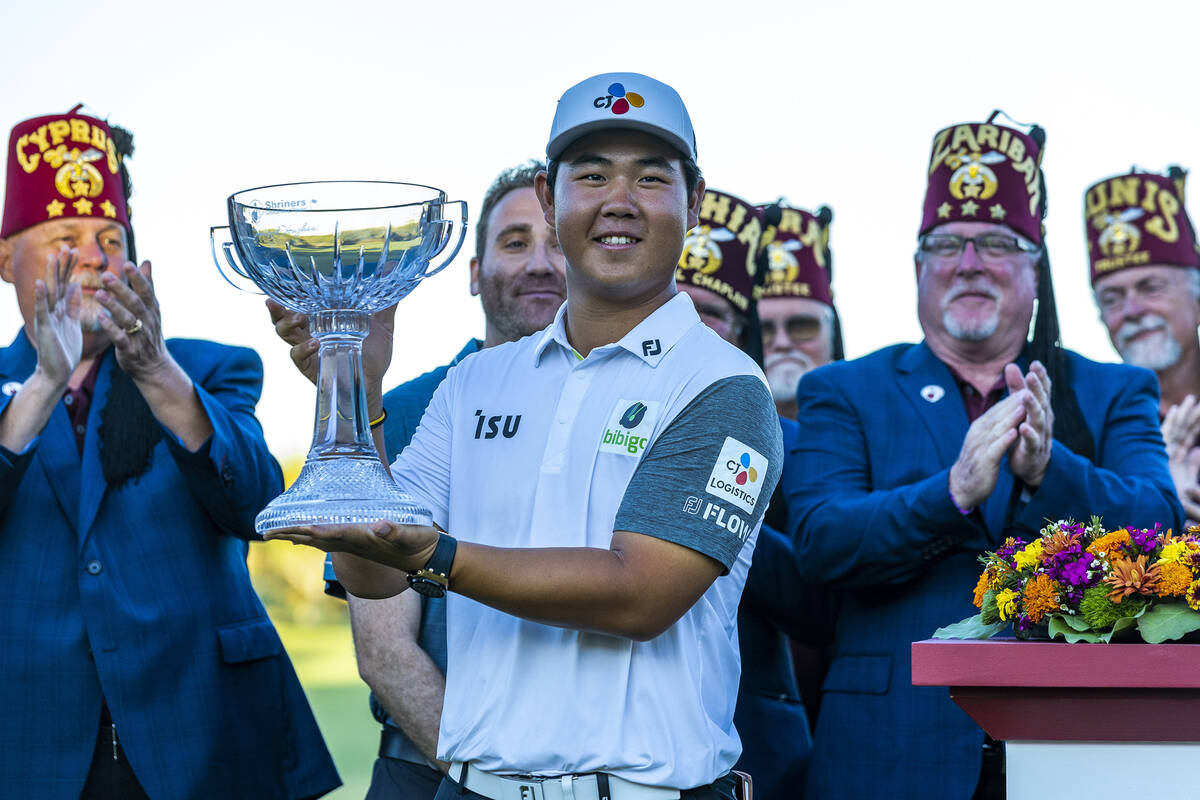 Tom Kim holds up his winning trophy during the final day of play in the Shriners Children's Ope ...