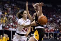 UNLV Lady Rebels guard Essence Booker (24) passes around Wyoming Cowgirls center Allyson Fertig ...