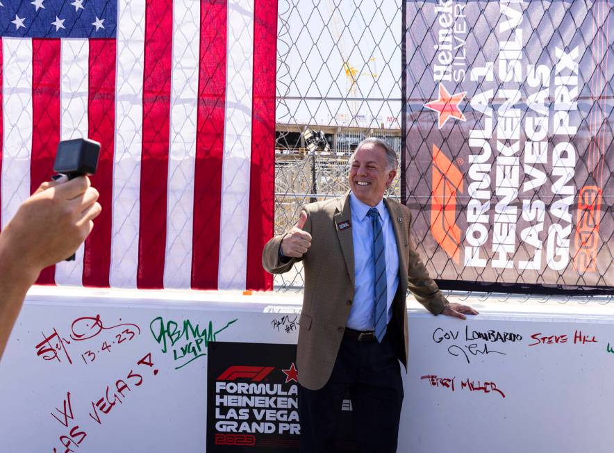 Gov. Joe Lombardo flashes a thumbs up after signing on a barrier during a topping off ceremony ...