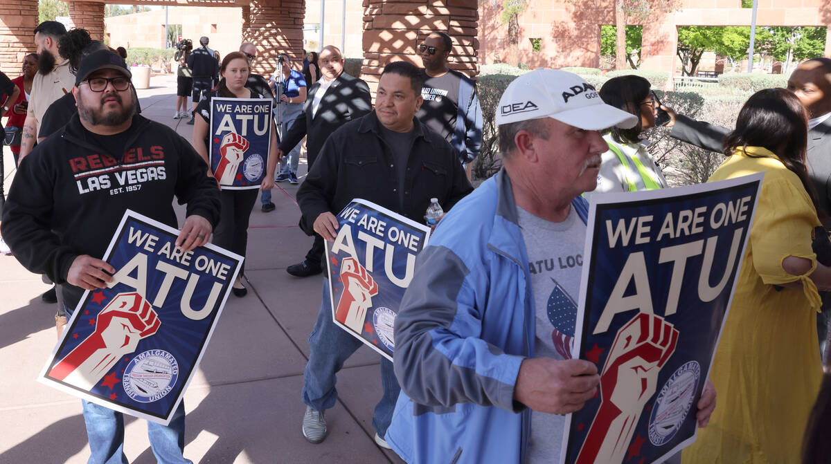 Members of the Amalgamated Transit Union, Local 1637, walk into the Clark County Government Cen ...