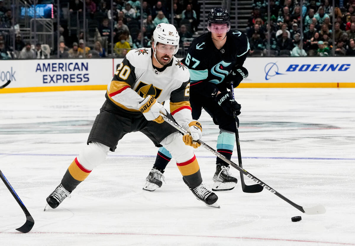 Vegas Golden Knights center Chandler Stephenson (20) handles the puck in front of Seattle Krake ...