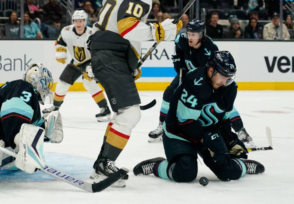 Seattle Kraken defenseman Jamie Oleksiak (24) blocks a Vegas Golden Knights shot with his knees ...