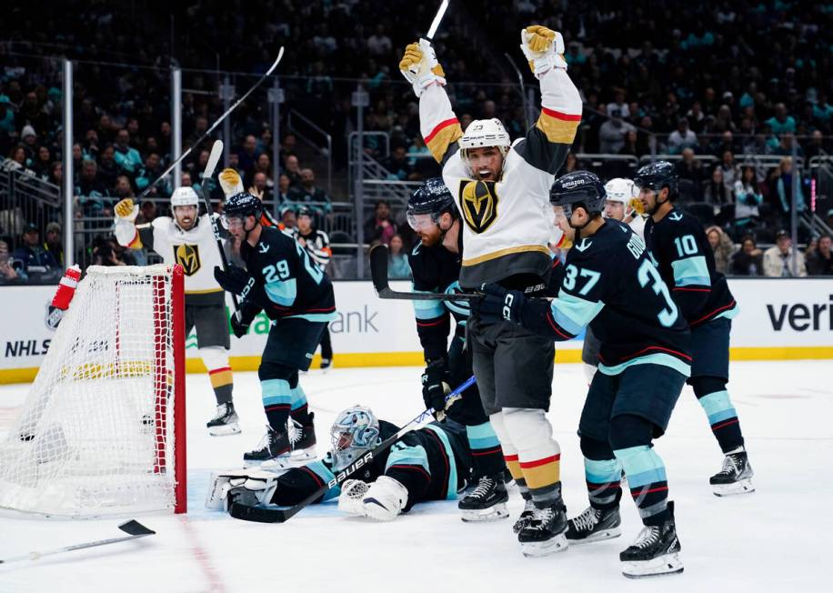 Vegas Golden Knights defenseman Alec Martinez, front left, celebrates his goal against Seattle ...