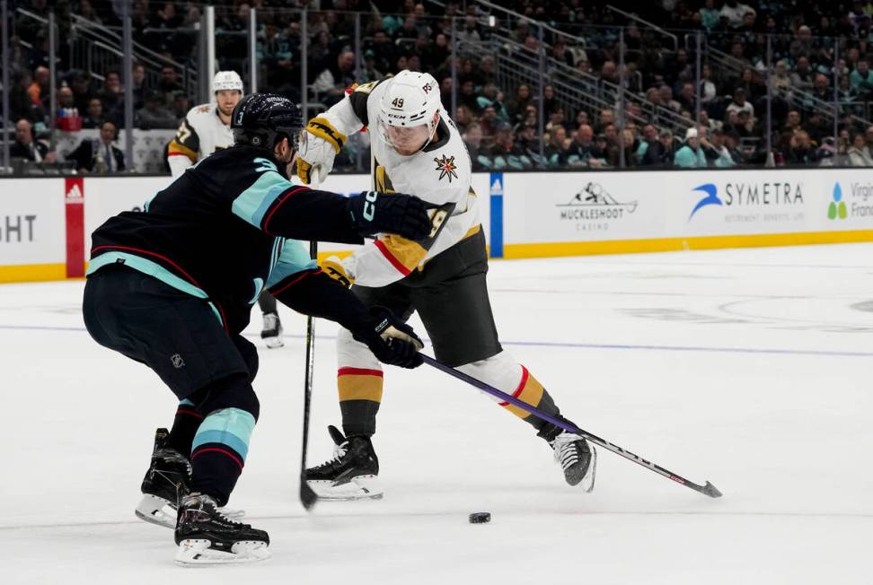 Vegas Golden Knights center Ivan Barbashev (49) looks to shoot around Seattle Kraken defenseman ...