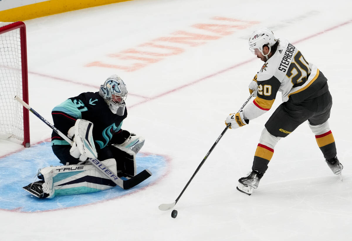 Vegas Golden Knights center Chandler Stephenson (20) loses control of the puck while trying to ...