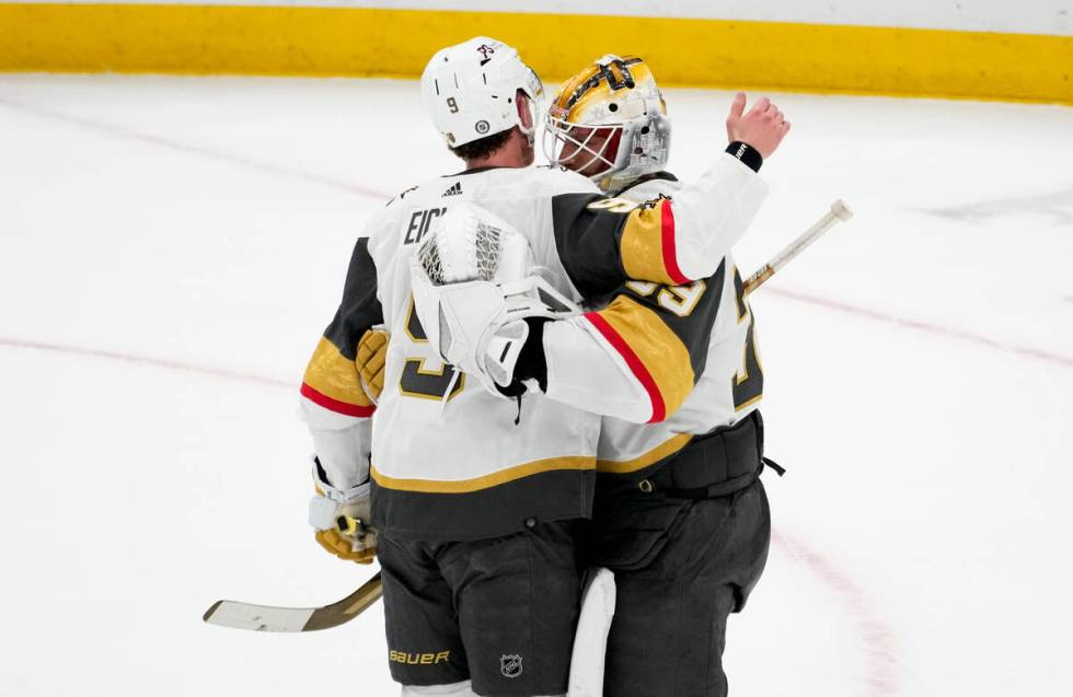 Vegas Golden Knights center Jack Eichel, left, greets goaltender Laurent Brossoit as they celeb ...