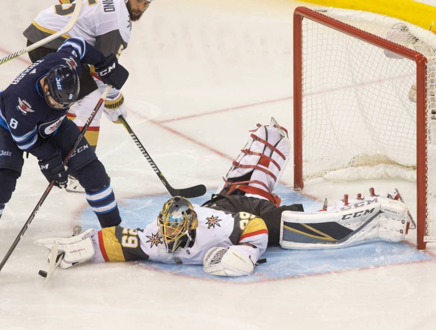 Golden Knights goaltender Marc-Andre Fleury (29) makes a save against Jets defenseman Jacob Tro ...