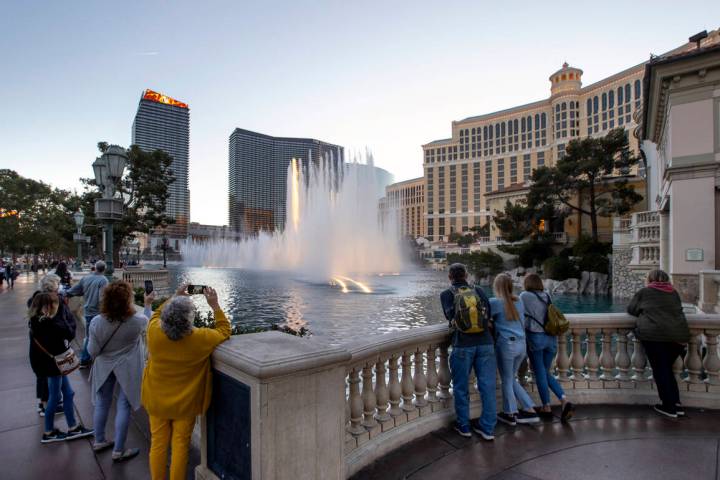 People watch the Bellagio Fountains in January 2022 in Las Vegas. (L.E. Baskow/Las Vegas Review ...