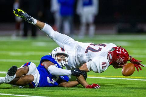 Arbor View MLB Christian Thatcher (42) dives for a fumble as Liberty RB Isaiah Lauofo (3) holds ...