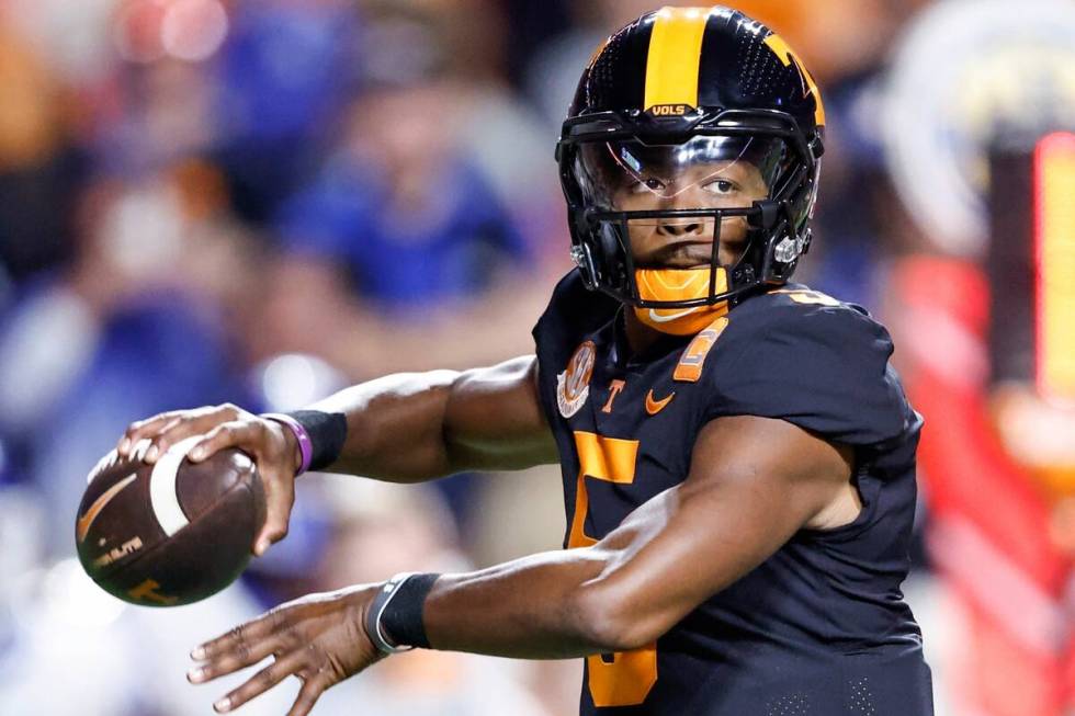 FILE - Tennessee quarterback Hendon Hooker (5) throws to a receiver during the first half of an ...