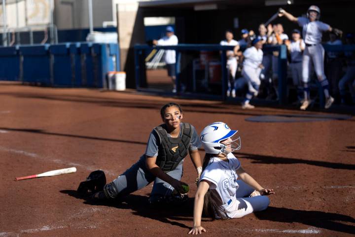 Bishop Gorman’s Allie Bernardo looks to the umpire after sliding into home plate safely ...