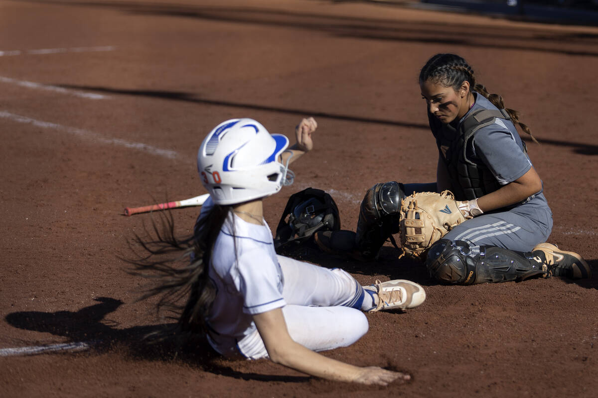 Tech catcher Marlene Saldate fumbles a catch while Bishop Gorman’s Allie Bernardo slides ...