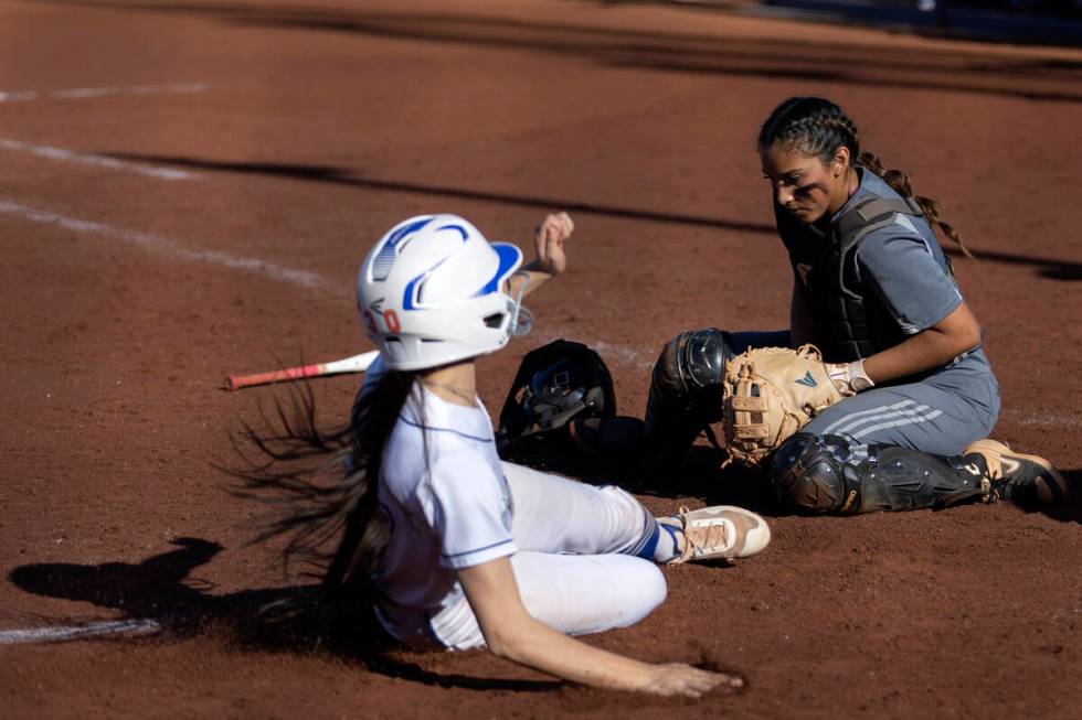 Tech catcher Marlene Saldate fumbles a catch while Bishop Gorman’s Allie Bernardo slides ...