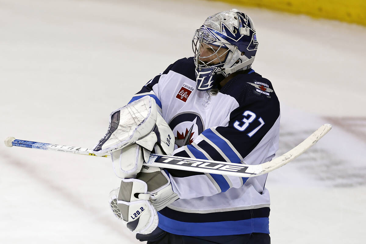 Winnipeg Jets goaltender Connor Hellebuyck reacts after the third period of an NHL hockey game ...