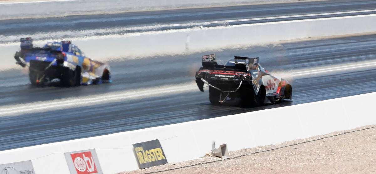 NHRA driver Matt Hagan, right, competes with Ron Capps, left, in the first Nitro qualifying ses ...