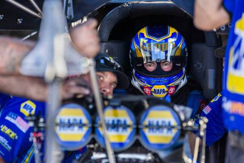 Funny Car driver Ron Capps awaits patiently as his crew finalizes adjustments before another qu ...