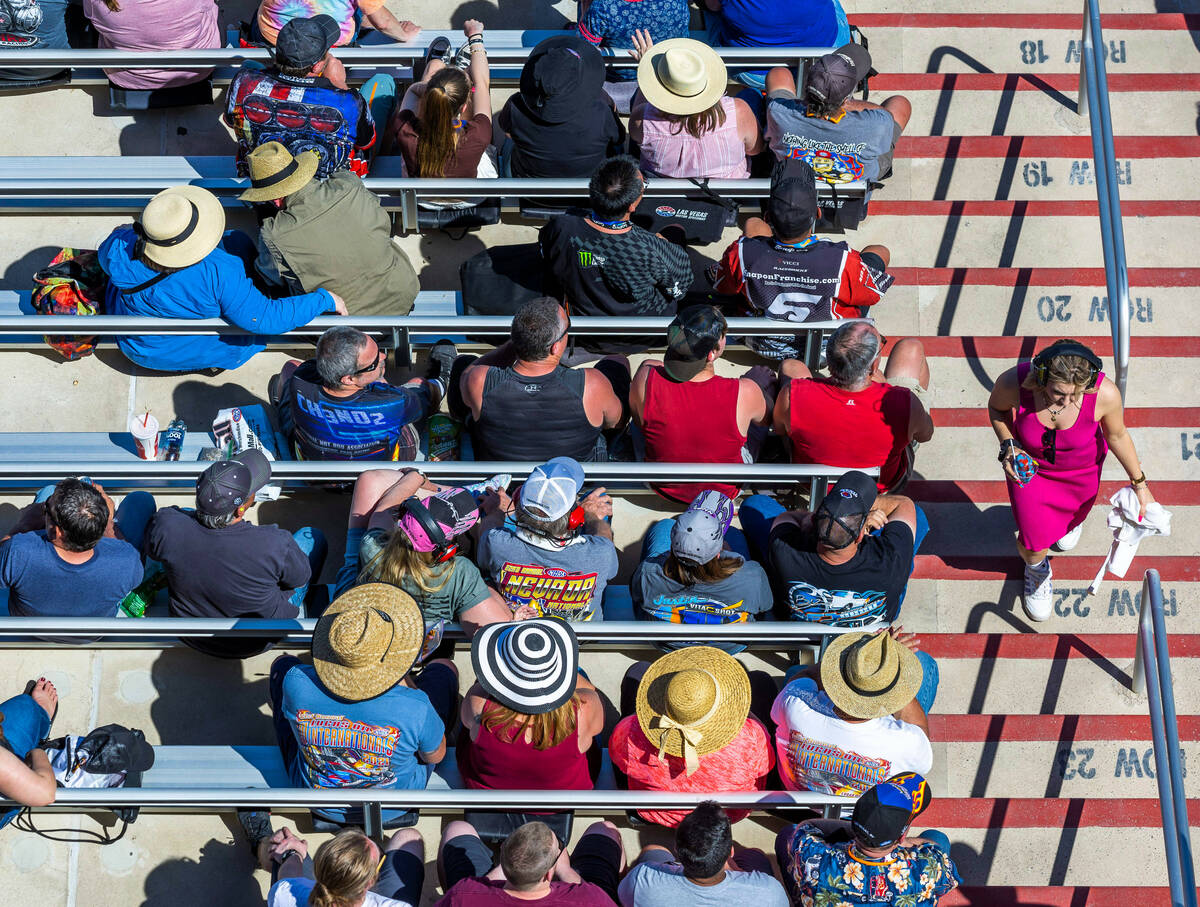 Fans wear a variety of hats on a sunny day in the stands during Day 2 of NHRA Nationals at the ...