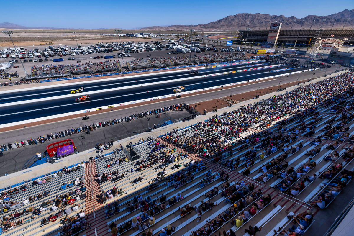 As fans look on Funny Cars compete in qualifying during Day 2 of NHRA Nationals at the Las Vega ...