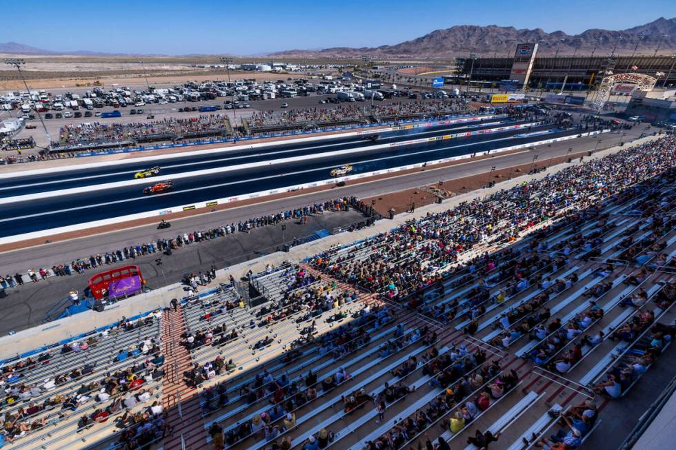 As fans look on Funny Cars compete in qualifying during Day 2 of NHRA Nationals at the Las Vega ...
