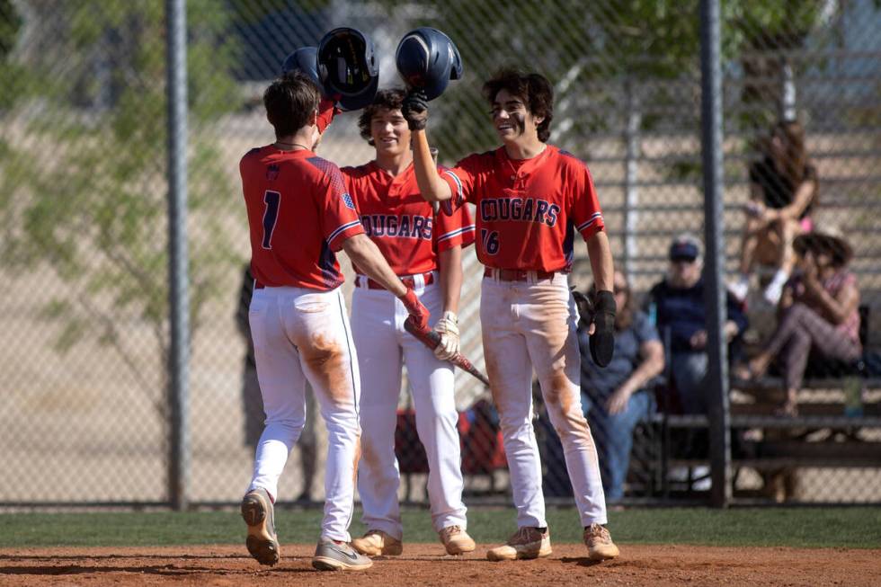 Coronado’s Noah Wong, center, and Nick Morrison (16) congratulate their teammate Evan Fe ...