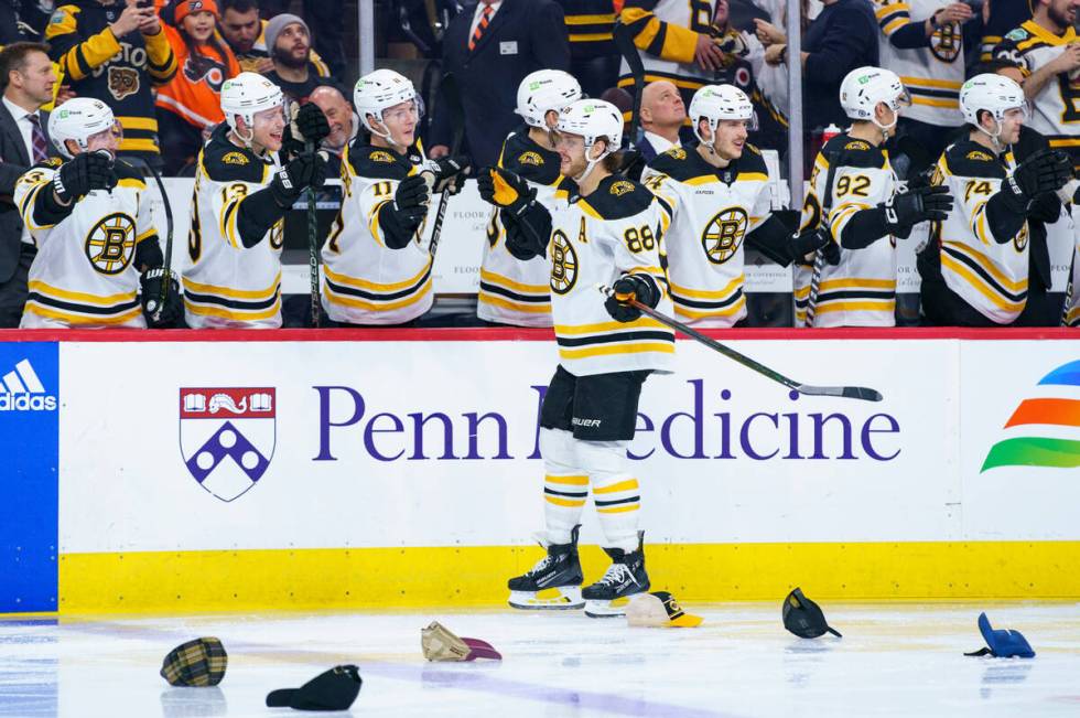 Boston Bruins' David Pastrnak, center, celebrates his third goal with teammates as he skates pa ...