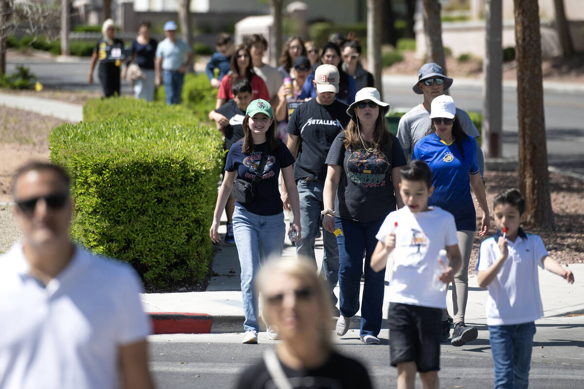 People walk along during the Six Million Steps gathering at The Hills Park on April 16, 2023, i ...