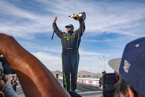 Matt Hagan greets fans after winning the funny car competition at the 4-wide NHRA Nationals at ...