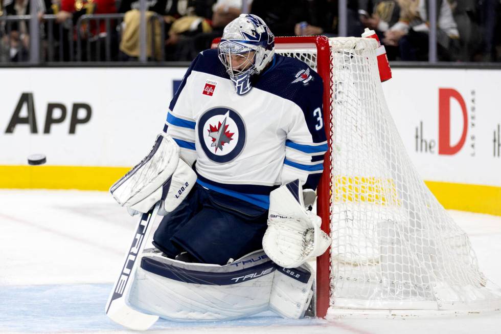 Jets goaltender Connor Hellebuyck (37) prepares to save a Golden Knights shot on goal during th ...