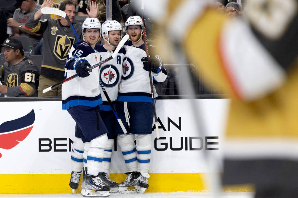 Jets center Mark Scheifele (55), defenseman Josh Morrissey (44) and left wing Kyle Connor (81) ...