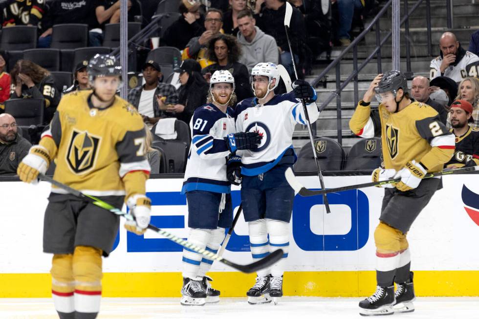 Jets left wing Kyle Connor (81) and right wing Saku Maenalanen (8) celebrate after scoring whil ...