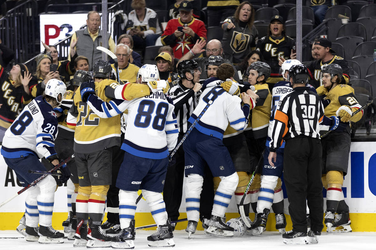 The Golden Knights and the Jets fight during the third period in Game 1 of an NHL hockey Stanle ...