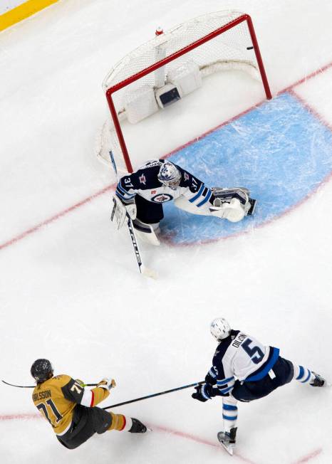 Golden Knights center William Karlsson (71) scores on Jets goaltender Connor Hellebuyck (37) wh ...