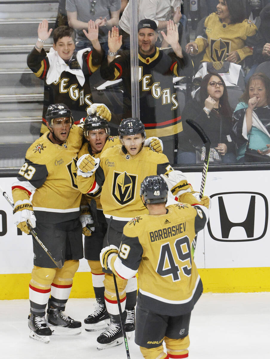 Golden Knights center William Karlsson (71), third from left, is congratulated by his teammates ...